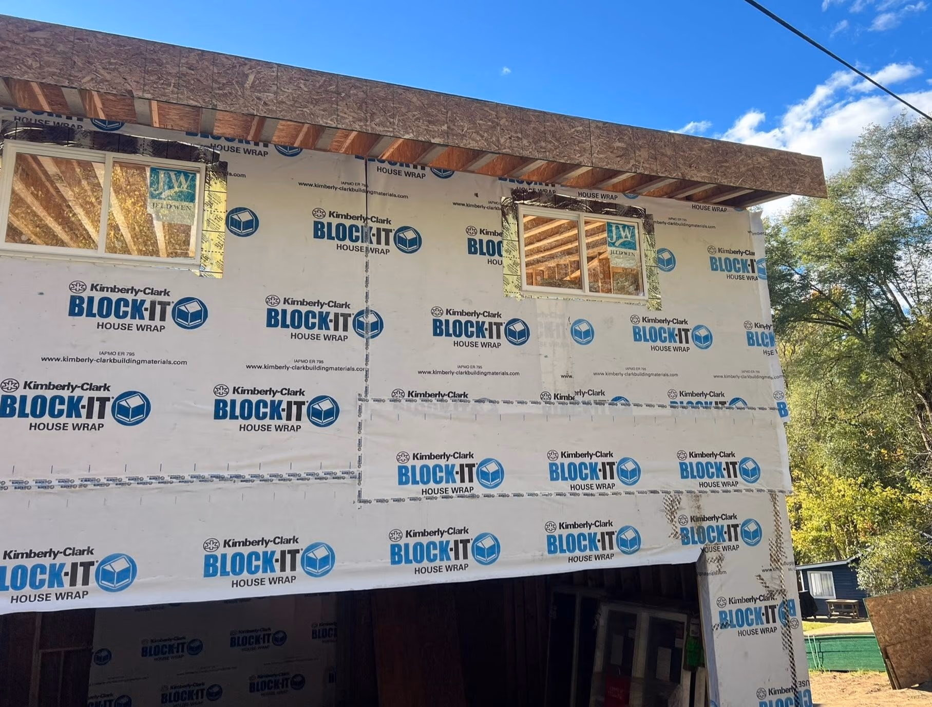 Partially constructed building with Kimberly-Clark BLOCK-IT house wrap and two windows installed.